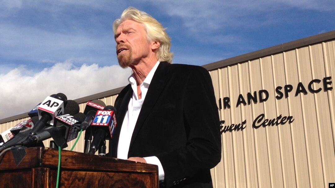 FILE - Billionaire Virgin Galactic founder Richard Branson salutes the bravery of test pilots during a news conference in Mojave, Calif., Nov. 1, 2014. Virgin Galactic announced a new version of its space tourism rocket.
