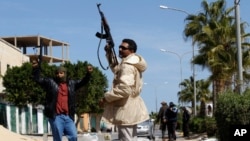 Gunmen opposed to leader Moammar Gadhafi holding their weapons are seen in the center of the city of Zawiyah, 50 km west of the capital Tripoli, March 5, 2011