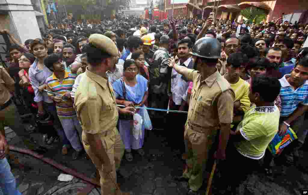 Crowds gathers outside. The fire has left leaving dozens dead, many from smoke inhalation. (AP/Anupam Nath)