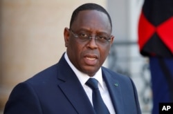 Senegal's President Macky Sall leaves after meeting with French President Emmanuel Macron and other state leaders at the Elysee Palace in Paris, Wednesday May 15, 2019.