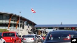 FILE - Traffic enters Canada from the United States at the Peace Arch Border Crossing in Blaine, Washington, Oct. 9, 2019. More than 60 Iranians and Iranian-Americans reportedly were detained and questioned at the border crossing over the weekend.