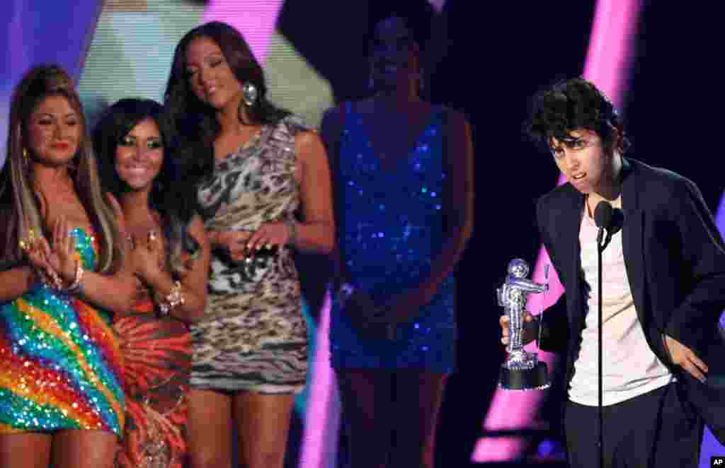 August 28: Lady Gaga, dressed as a man, accepts the award for best female video for "Born This Way" from the presenters who were part of the TV series "Jersey Shore", at the MTV Video Music Awards in Los Angeles. REUTERS/Mario Anzuoni