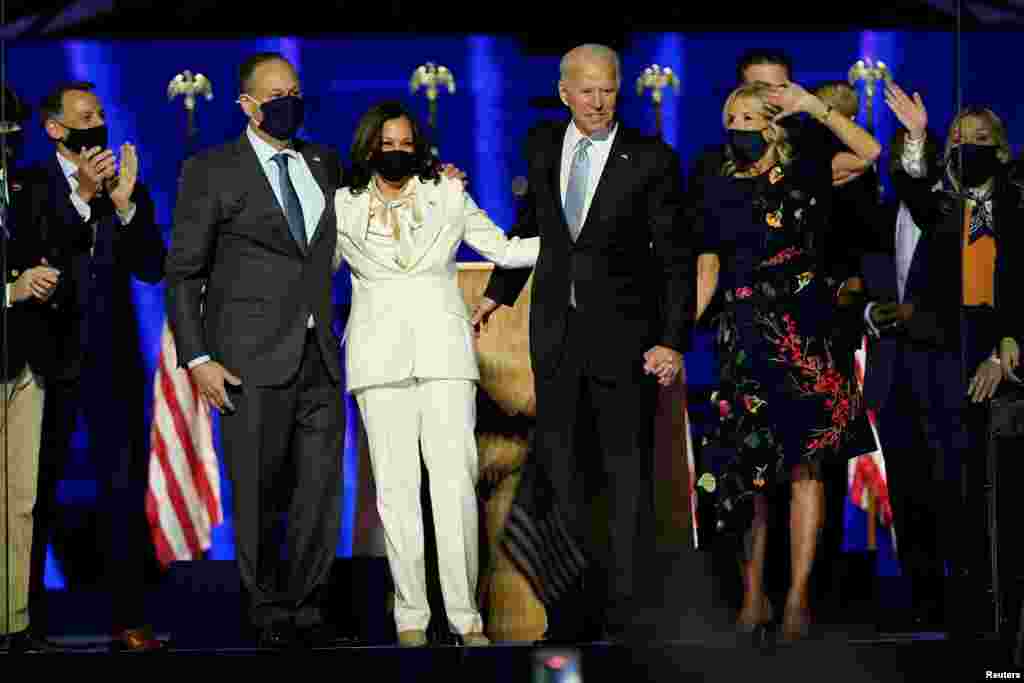 Democratic 2020 U.S. presidential nominee Joe Biden and his wife Jill, and Democratic 2020 U.S. vice presidential nominee Kamala Harris and her husband Doug, react to the confetti at their election rally.