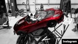 "Starman" sits behind the wheel of a Tesla roadster in this photo posted to the Instagram account of Elon Musk, head of the Tesla car company and founder of SpaceX.