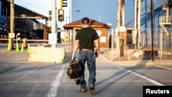 FILE - A steel worker returns to work after a being idle for two years at U.S. Steel Granite City Works in Granite City, Ill., May 24, 2018.