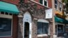 FILE - Burned bricks on a modern storefront are one of the few surviving reminders of the more than 30-block historic Black district in Tulsa, Okla., June 15, 2020.