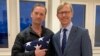 This photo released by the U.S. State Department shows Navy veteran Michael White, left, posing with Special Envoy to Iran Brian Hook at Zurich Airport in Zurich, Switzerland, June 4, 2020, after White was released from Iran.