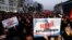 FILE - Protesters carry banners reading 'No refugee home' during an Austrian Freedom Party (FPOe) demonstration in Vienna, March 14, 2016. 