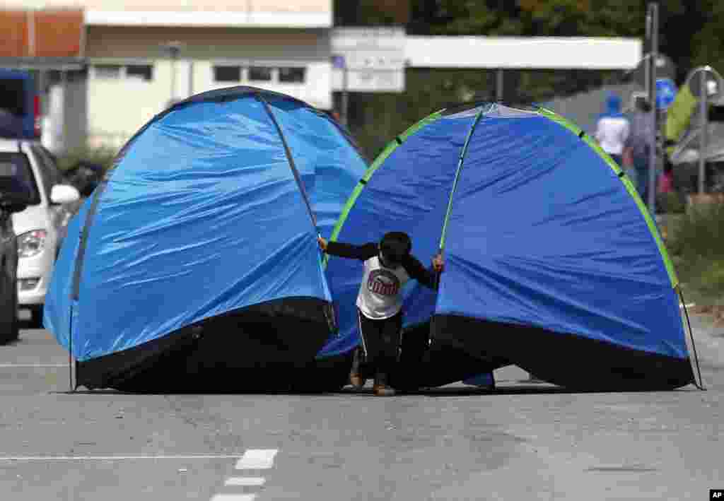 A migrant boy pulls tents on the road near the &quot;Horgos 2&quot; border crossing into the Hungary, near Horgos.