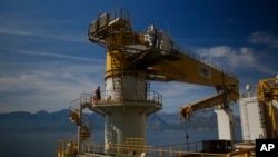 FILE - A worker walks on Turkey's new drillship 'Conquerer' off the coast of Antalya, southern Turkey, Oct. 30, 2018.