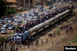 Sudanese civilians ride on the train to join the celebrations of the signing of the power sharing deal, that paves the way for a transitional government, in Khartoum, Aug. 17, 2019.