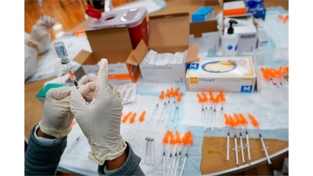 FILE - A registered nurse fills a syringe with the Johnson & Johnson COVID-19 vaccine at a pop-up vaccination site at the Albanian Islamic Cultural Center in the Staten Island borough of New York, April 8, 2021.