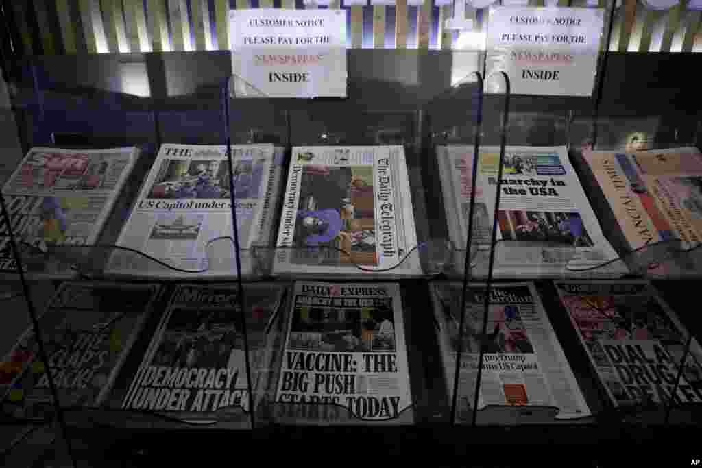 British national newspapers, with front pages reporting on the mob loyal to President Donald Trump storming the U.S. Capitol, are displayed for sale outside a store in London.