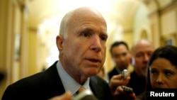 Senator John McCain, an Arizona Republican, speaks to reporters as he arrives for the Republican policy luncheon on Capitol Hill in Washington, Feb. 14, 2017. 