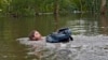 Connor Hughes moves in deep floodwaters left by Hurricane Milton along the Alafia River on Oct. 11, 2024, in Lithia, Florida.