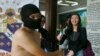 © Student receives rose from protester during naked run to condemn last week's burial of late dictator Ferdinand Marcos at the Heroes' Cemetery, Quezon City, Philippines, Nov. 25, 2016.