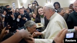 Pope Francis greets residents of Varginha slum inside the local church, in Rio de Janeiro, Brazil, July 25, 2013.