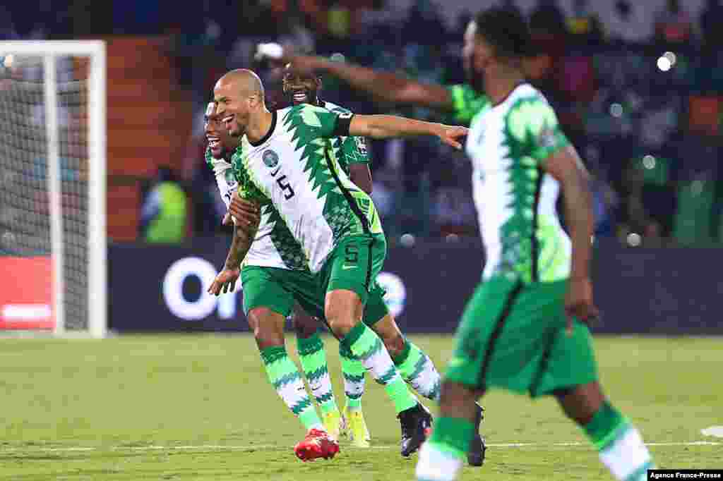 Nigeria's defender William Troost-Ekong (L) celebrates after scoring his team's second goal during the football match between Guinea-Bissau and Nigeria in Cameroon on Jan. 19, 2022.