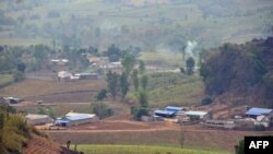 FILE - This picture taken on April 6, 2015 shows Chinese national flags flying on the border between Kokang and China's Nansan township in Lincang, southwest China's Yunnan province.