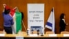 FILE - Israeli parliament employees set up a Palestinian and Israeli flag ahead of a meeting between Israeli parliament members and a delegation of Palestinian politicians and businessmen aimed at encouraging Israeli-Palestinian negotiations, at the Knesset, the Israeli parliament, in Jerusalem, July 31, 2013.