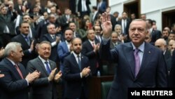 Turkish President Tayyip Erdogan greets members of his ruling AK Party during a meeting at the Parliament in Ankara, Turkey, Feb. 19, 2020. 
