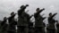 Romanian troops march during the national day military parade in Bucharest, Dec. 1, 2017. Key politicians didn't attend, signaling tensions between the president and the ruling left-wing coalition over plans to revamp the justice system.