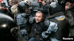 Московская полиция задерживает правозащитника Льва Пономарева во время акции протеста российской оппозиции. Архивное фото. 