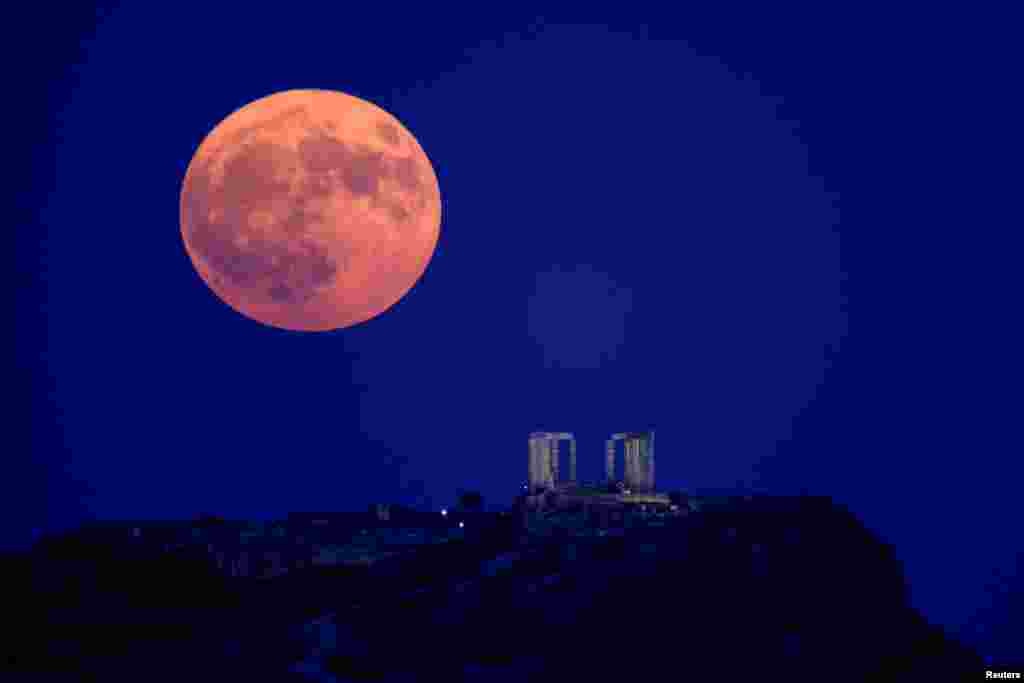 A supermoon rises over the Temple of Poseidon, on Cape Sounion, near Athens, Greece, Aug. 19, 2024.&nbsp;