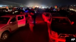 Afghan military and officials leave Kandahar city during fighting between the Taliban and Afghan security personnel, in Kandahar, southwest of Kabul, Afghanistan, Thursday, Aug. 12, 2021. (AP Photo/Sidiqullah Khan)