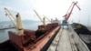 FILE - A cargo ship is loaded with coal at the North Korean port of Rajin, July 18, 2014. 