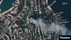 FILE: Satellite imagery shows smoke billowing from a Russian Naval HQ after Ukrainian strike