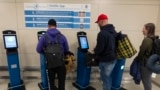 International travelers stop and use the portal to get their initial processing and instructions on their next procedure, in the port of entry at Washington Dulles International Airport in Chantilly, Va. Monday, April 1, 2024. (AP Photo/Manuel Balce Ceneta)