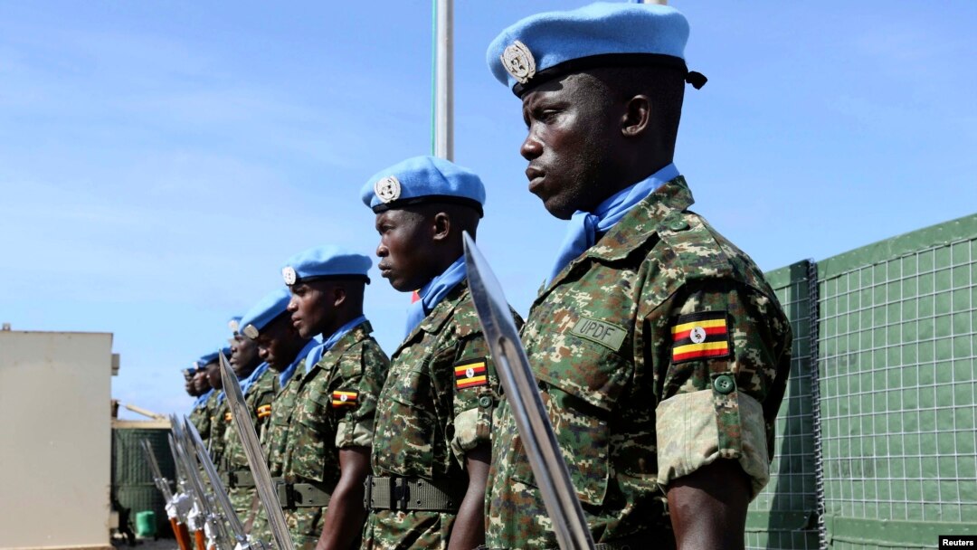 Ugandan peacekeeping troops stand during a ceremony at Mogadishu airport in Somalia May 18, 2014. U.N.-backed peacekeepers pushed the Islamist fighters out of Mogadishu in 2011, but the al Qaida-linked group has continued to launch guerrilla-style attacks.