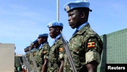 Ugandan peacekeeping troops stand during a ceremony at Mogadishu airport in Somalia May 18, 2014. U.N.-backed peacekeepers pushed the Islamist fighters out of Mogadishu in 2011, but the al Qaida-linked group has continued to launch guerrilla-style attacks.