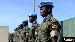 Ugandan peacekeeping troops stand during a ceremony at Mogadishu airport in Somalia May 18, 2014. 