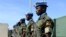 FILE - Ugandan peacekeeping troops stand during a ceremony at Mogadishu airport in Somalia.