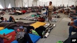 Central American migrants settle in a shelter at the Jesus Martinez stadium in Mexico City, in Mexico City, Jan. 28, 2019.