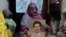 Pakistan Execution: Safia Bano displays the picture of her husband Imdad Ali, a death row prisoner, while she sits with other family members in Burewala, in central Pakistan, Sunday, Sept. 18, 2016. 