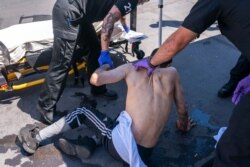 FILE - In this June 26, 2021, photo, paramedics respond to a heat exposure call at a cooling center during a heat wave in Salem, Ore.