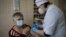 A medical worker administers a shot of Russia's coronavirus vaccine to an elderly woman in Korenovsk, Krasnodar region, 1,151 kilometers south of Moscow, Russia, Saturday, Nov. 13, 2021. 