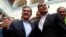 Ecuador President Rafael Correa, right, accompanies Augusto Barrera, left, of the ruling PAIS Alliance party and candidate for re-election as mayor of Quito after Barrera voted in local elections in Quito, Feb. 23, 2014. 