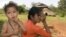 An ethnic minority Cambodian boy, left, stands next to his mother at a village in Mondul Kiri province some 265 kilometers (165 miles) northeast Phnom Penh, file photo. 