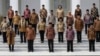 Indonesian President Joko Widodo, front row, center, and his deputy Jusuf Kalla, front row, second right, pose with the newly appointed cabinet ministers after their the inauguration ceremony at the presidential palace in Jakarta, Indonesia, Oct. 27, 2014