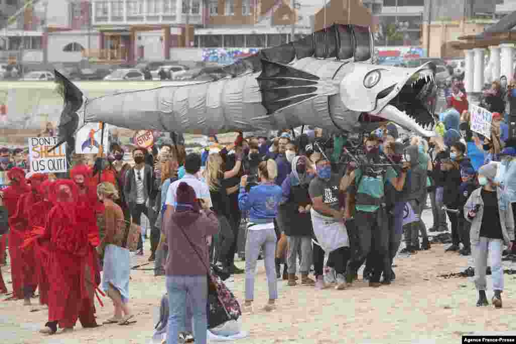 A giant puppet of a Snoek, a type of common local Mackeral, is displayed as hundreds of people take part in a protest against the plan by Dutch oil company, Shell, to conduct underwater seismic surveys along South Africa&#39;s East coast, at Muizenberg Beach in Cape Town.