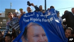 Pro-government protesters display a banner with the picture of Algerian President Abdelaziz Bouteflika in Algiers, March 5, 2011