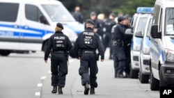 Police investigators secure the streets near the team hotel of soccer team Borussia Dortmund, in Dortmund, Germany, April 12, 2017, a day after their team bus was damaged in an explosion, injuring a player and a police officer. 