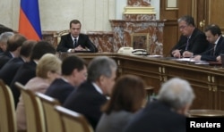 Russian Prime Minister Dmitry Medvedev, center rear, at a government meeting in Moscow, Russia, Nov. 26, 2015. Medvedev ordered measures drawn up that would include freezing some joint investment projects with Turkey.