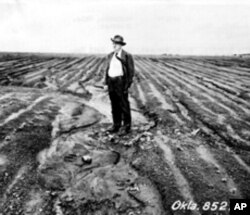 Hugh Haskell Bennett stands in a heavily eroded farm field near Haskell, Oklahoma, in 1943.