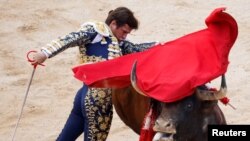Spanish bullfighter El Juli performs during a bullfight at the San Fermin festival in Pamplona, Spain.