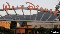 FILE - A portion of the signage at the main gate of The Walt Disney Co. is pictured in Burbank, California, May 7, 2012.